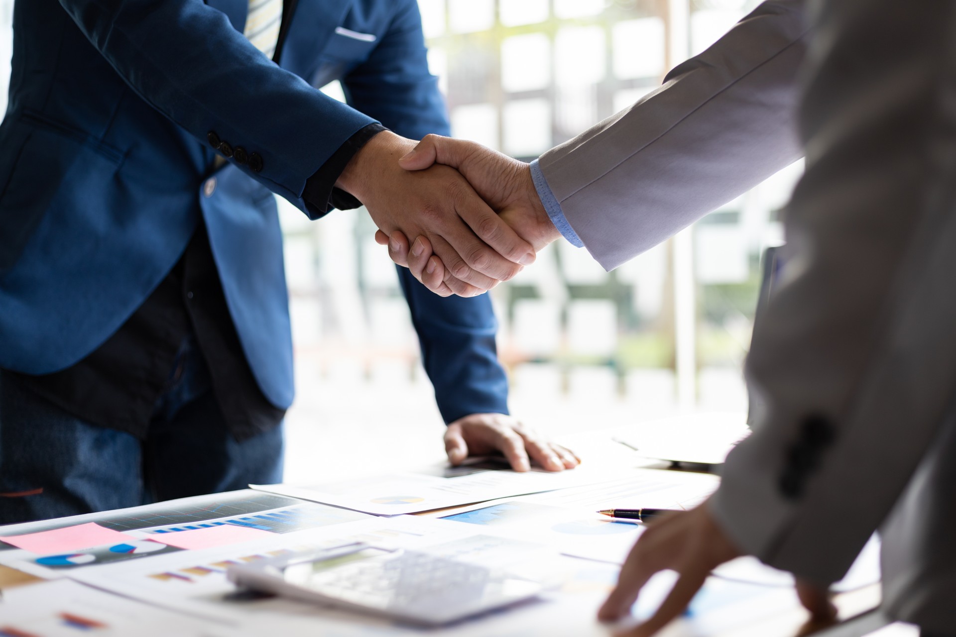 Business partner handshake after the meeting. Financial and investment cooperation.